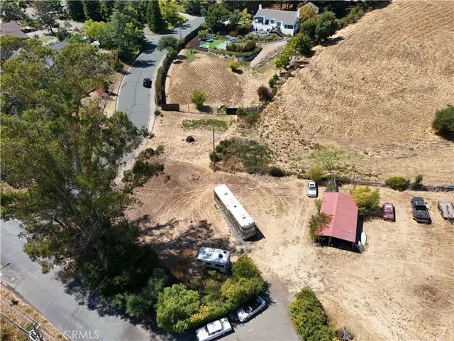 an aerial view of a house with a yard and lake view