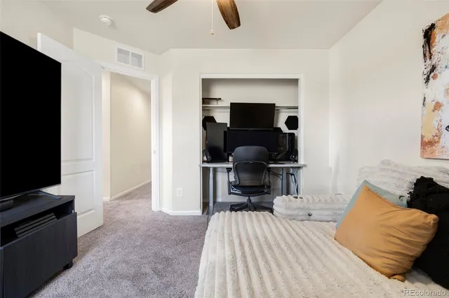 a bedroom with furniture and a flat screen tv