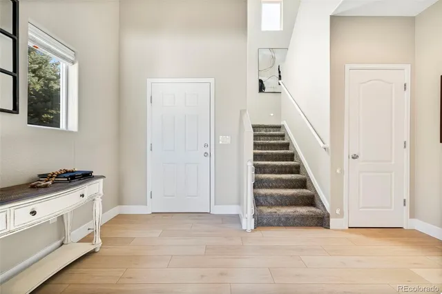 a view of entryway and hall with wooden floor