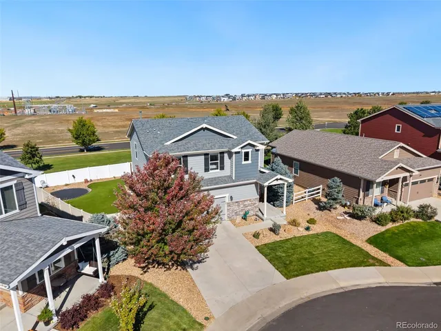 an aerial view of a house with a garden and lake view