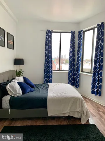 a bedroom with a bed couch and window
