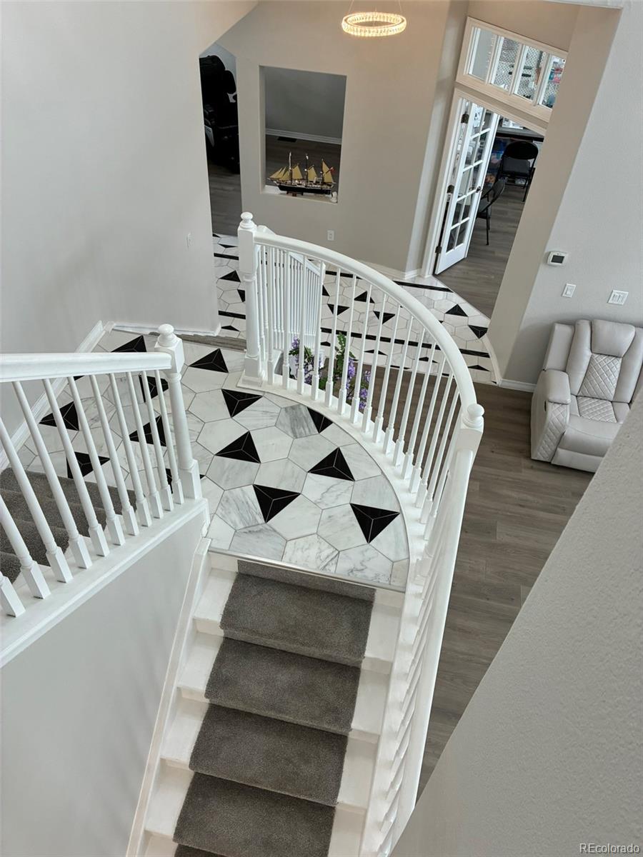 7242 South Rome Street Aurora, CO 80016 - Photo 7 of 33 a view of entryway and hall with wooden floor