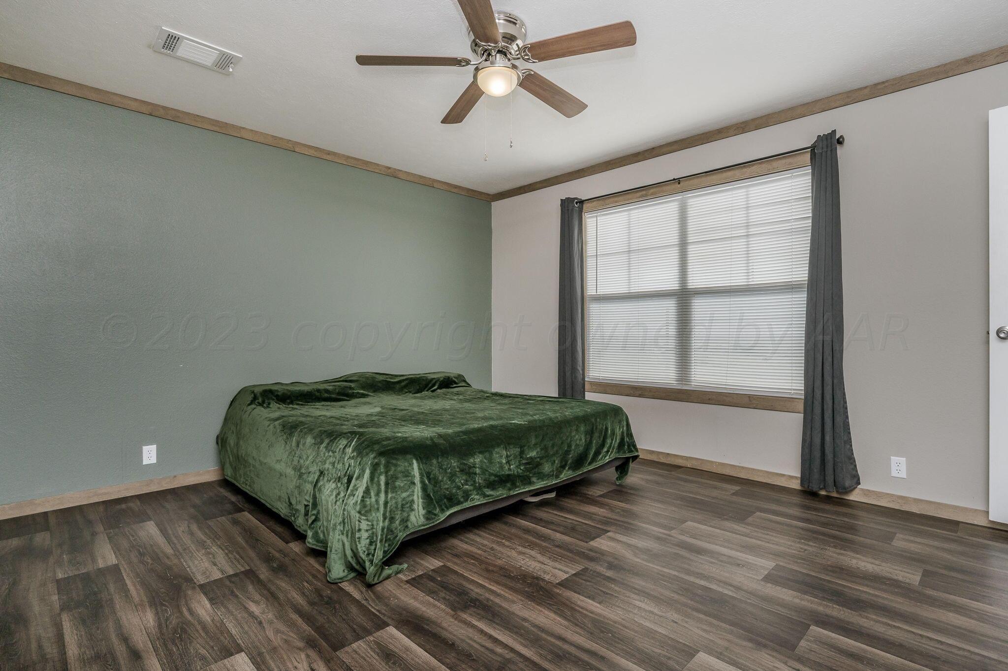 3557 Estates Drive Amarillo, TX 79124 - Photo 12 of 24 a bedroom with a bed and a window