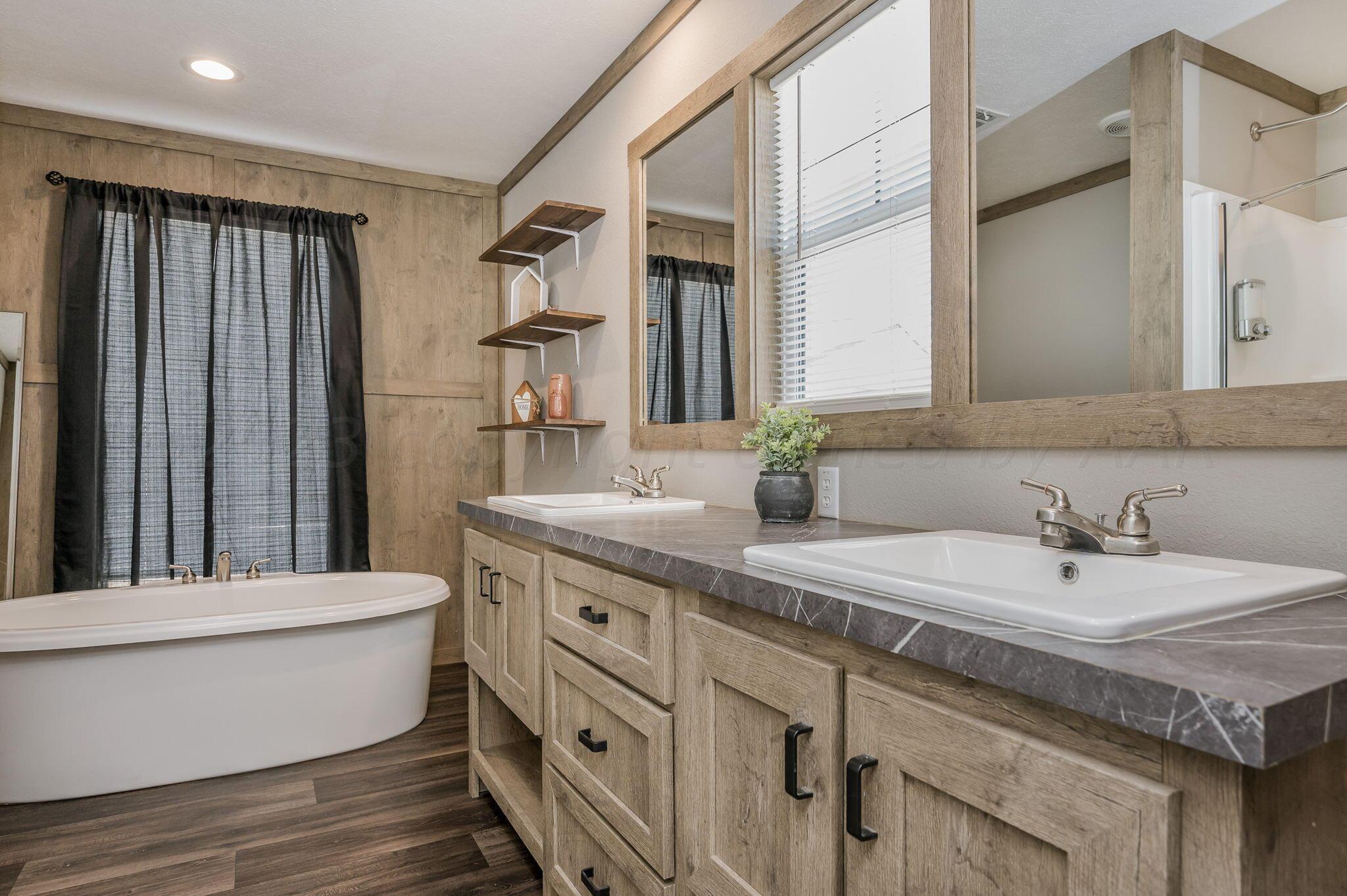 3557 Estates Drive Amarillo, TX 79124 - Photo 13 of 24 a bathroom with a double vanity sink and a mirror
