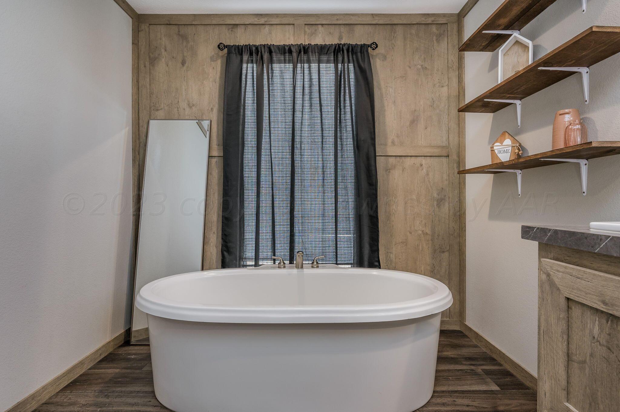 3557 Estates Drive Amarillo, TX 79124 - Photo 14 of 24 a bathroom with a sink and a mirror