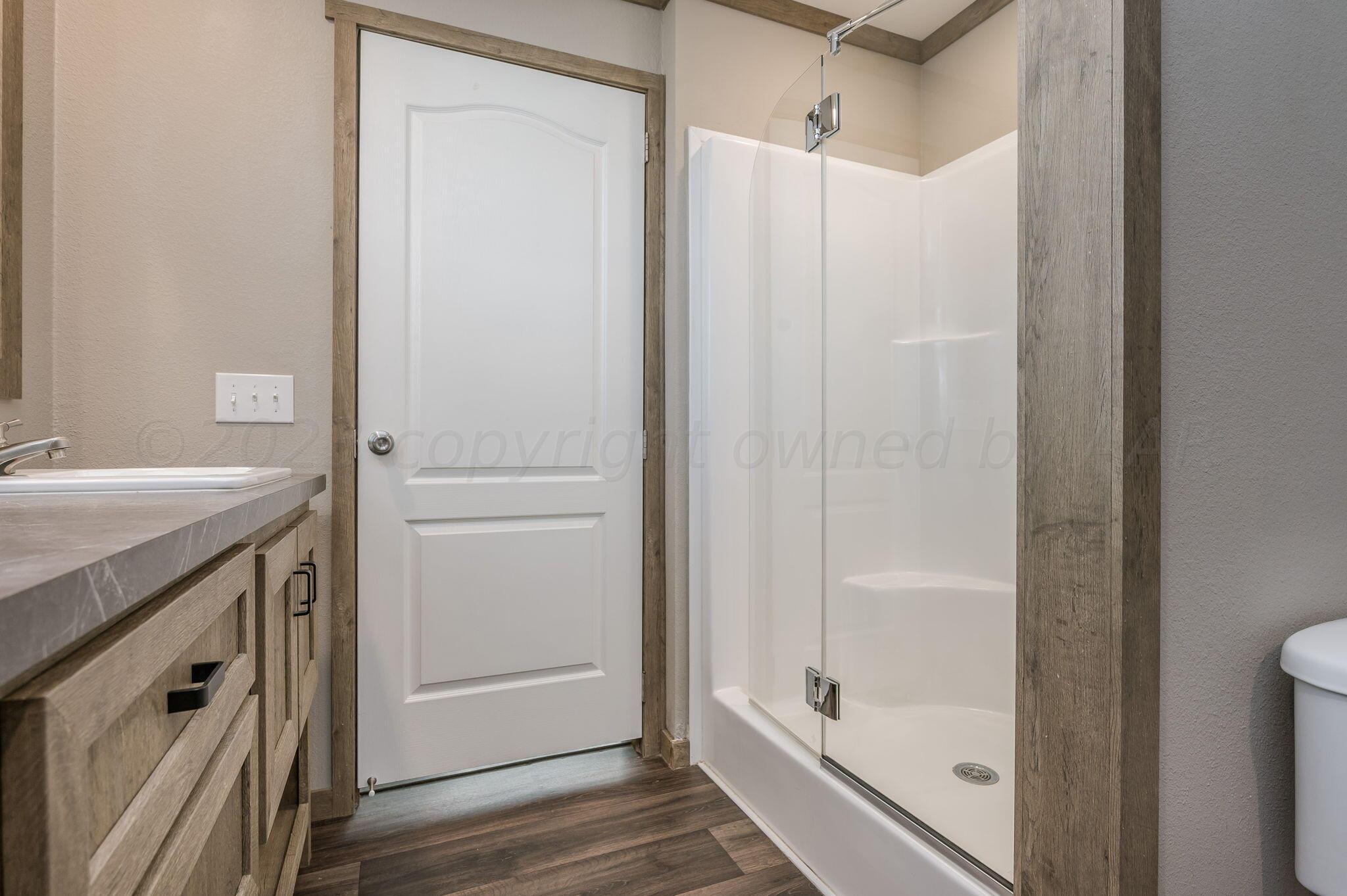 3557 Estates Drive Amarillo, TX 79124 - Photo 15 of 24 a bathroom with a shower and a sink