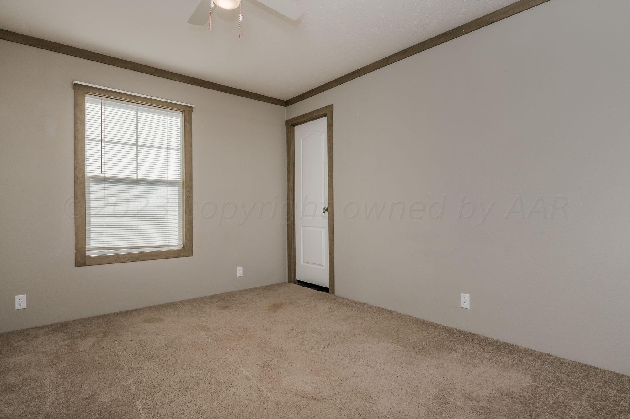 3557 Estates Drive Amarillo, TX 79124 - Photo 16 of 24 an empty room with a window and a ceiling fan