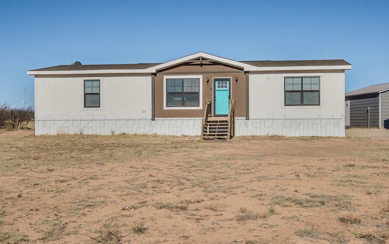 3557 Estates Drive Amarillo, TX 79124 - Photo 2 of 24 a front view of a house with a yard