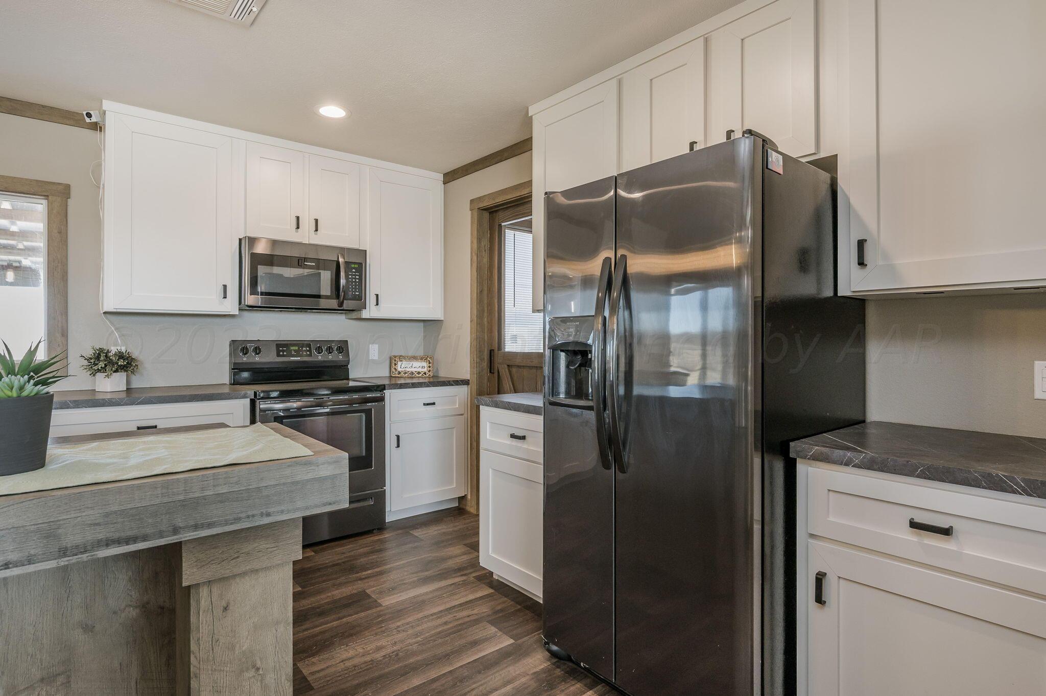 3557 Estates Drive Amarillo, TX 79124 - Photo 8 of 24 a kitchen with a refrigerator sink and microwave