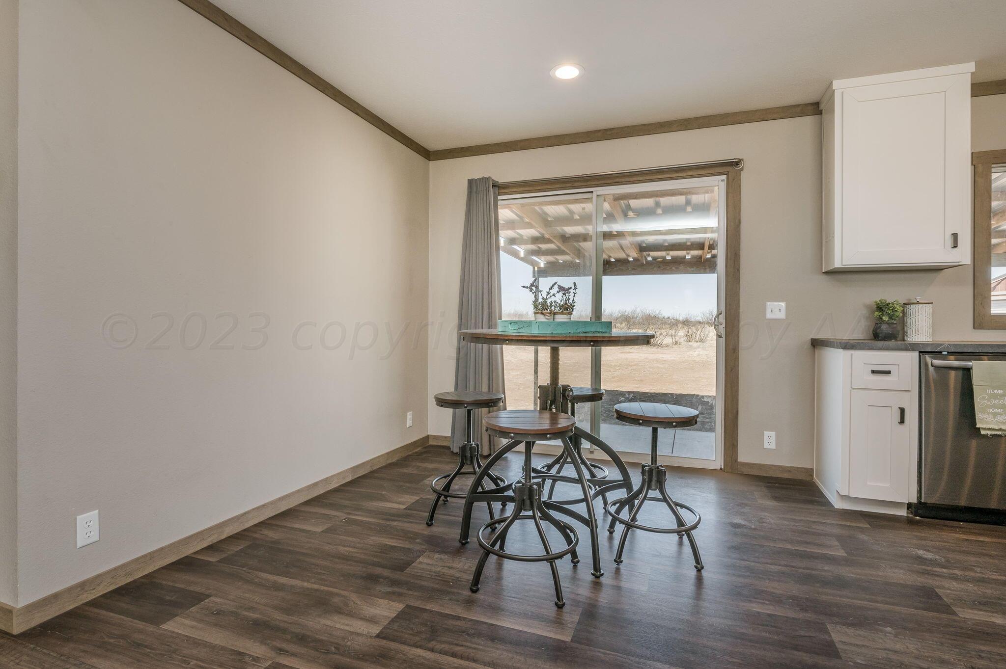 3557 Estates Drive Amarillo, TX 79124 - Photo 10 of 24 a view of a dining room with furniture and wooden floor