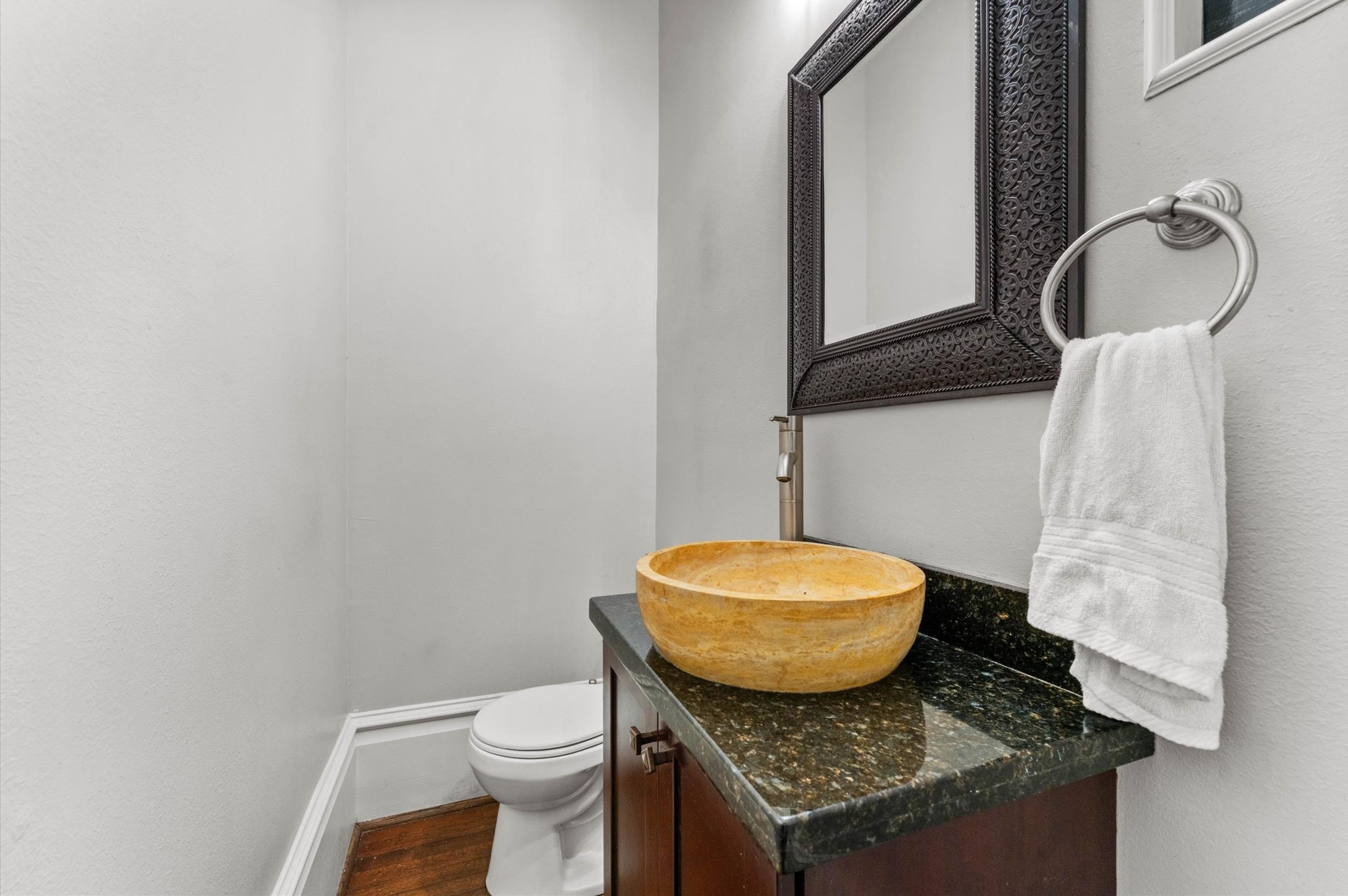 945 Harvard Street Houston, TX 77008 - Photo 18 of 47 a bathroom with a granite countertop toilet sink and mirror