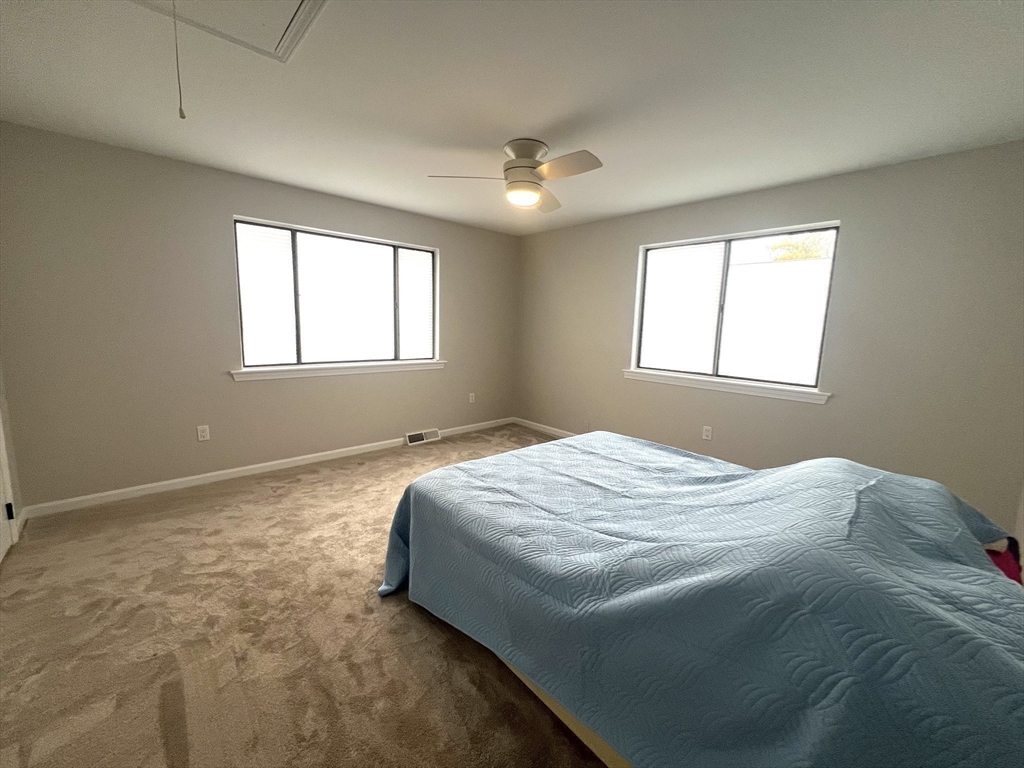 123 Chapin Road, Unit 1A4 Hudson, MA 01749 - Photo 23 of 32 a bed sitting in a bedroom next to a window