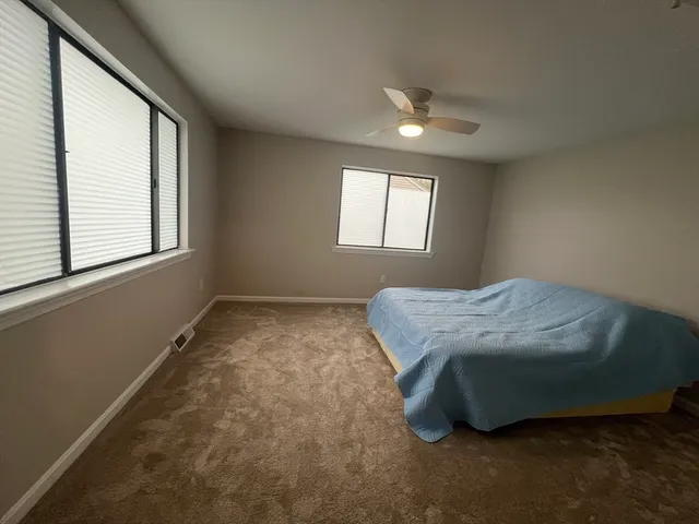 a room with a bed and a window