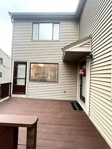 a view of a house with wooden deck