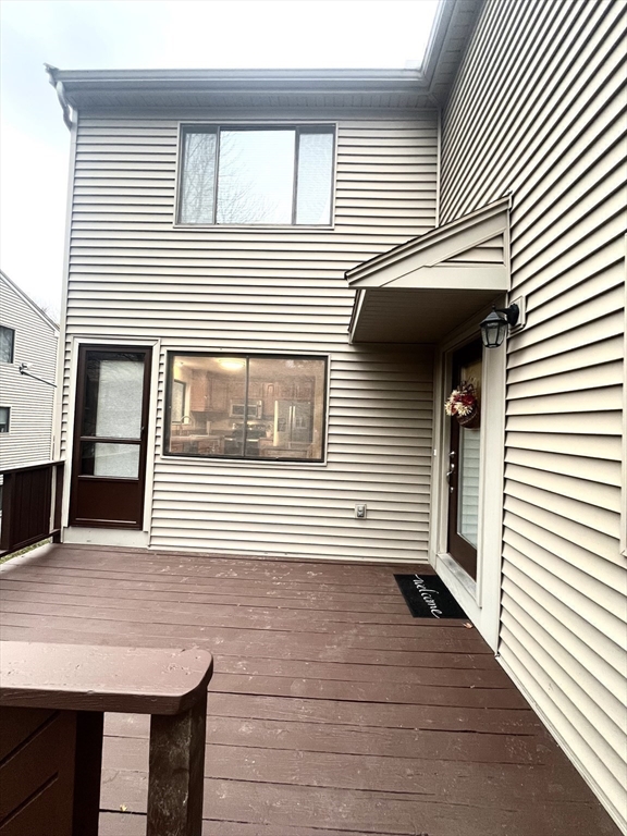 123 Chapin Road, Unit 1A4 Hudson, MA 01749 - Photo 4 of 32 a view of a house with wooden deck