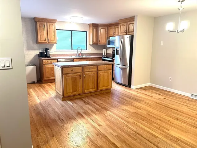 a kitchen with stainless steel appliances a stove a refrigerator and a sink