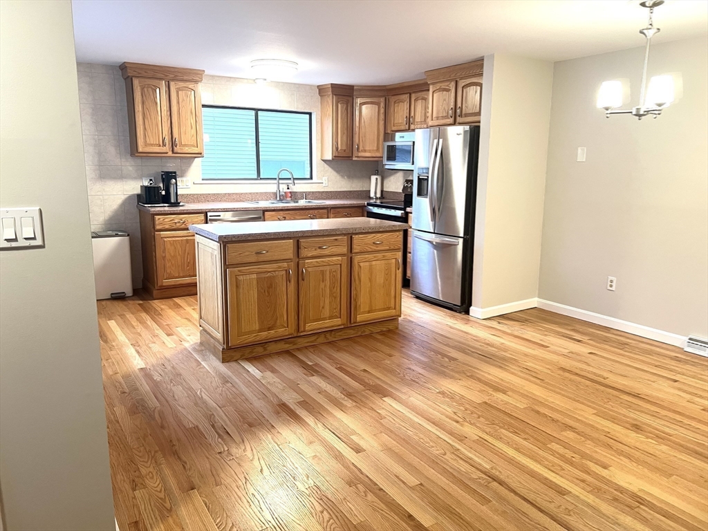 123 Chapin Road, Unit 1A4 Hudson, MA 01749 - Photo 9 of 32 a kitchen with stainless steel appliances a stove a refrigerator and a sink