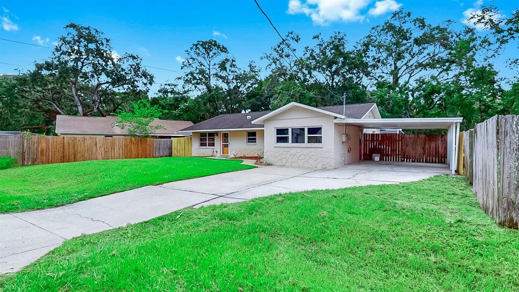 9210 Maynard Avenue New Port Richey, FL 34654 - Photo 1 of 1 a house that has garden in front of it
