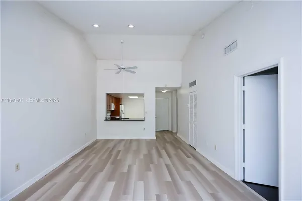 a view of a room with wooden floor and a window