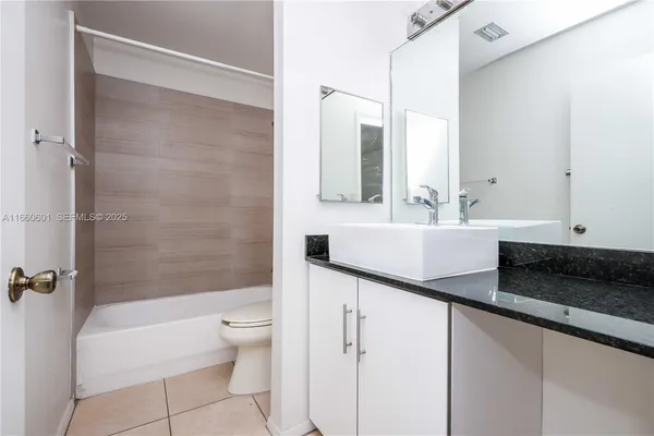 a bathroom with a sink a toilet and a bathtub