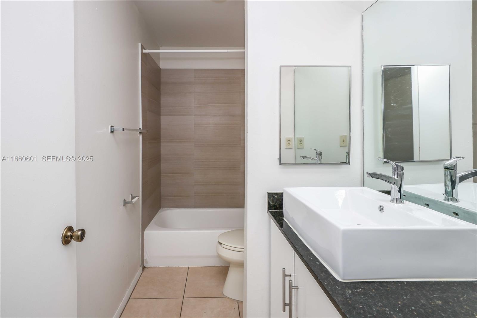 446 Southwest 113th Way, Unit 446 Pembroke Pines, FL 33025 - Photo 16 of 39 a bathroom with a sink a toilet and shower