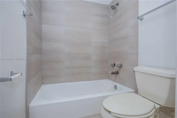 a white bath tub sitting next to a white toilet