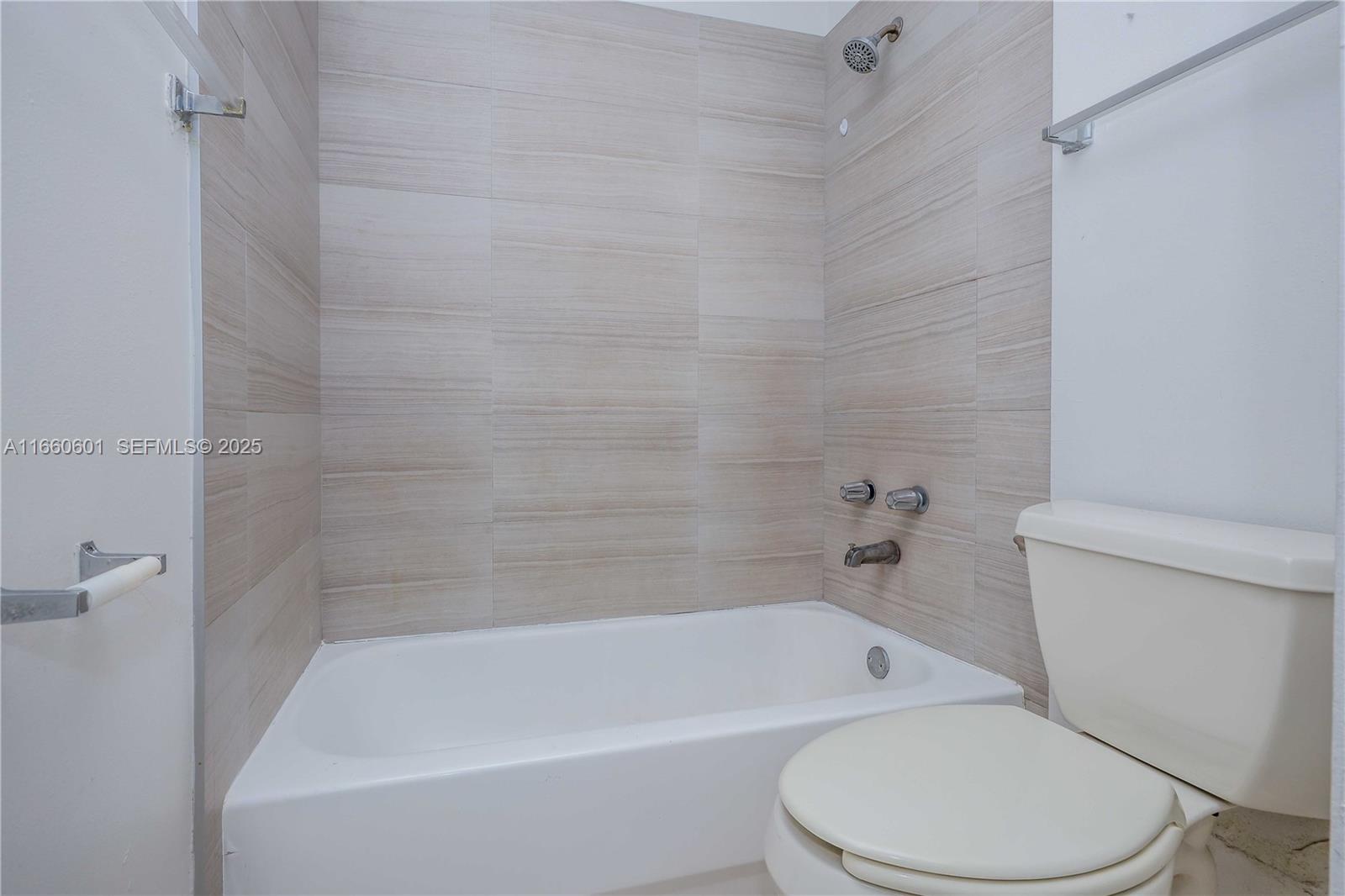 446 Southwest 113th Way, Unit 446 Pembroke Pines, FL 33025 - Photo 17 of 39 a white bath tub sitting next to a white toilet
