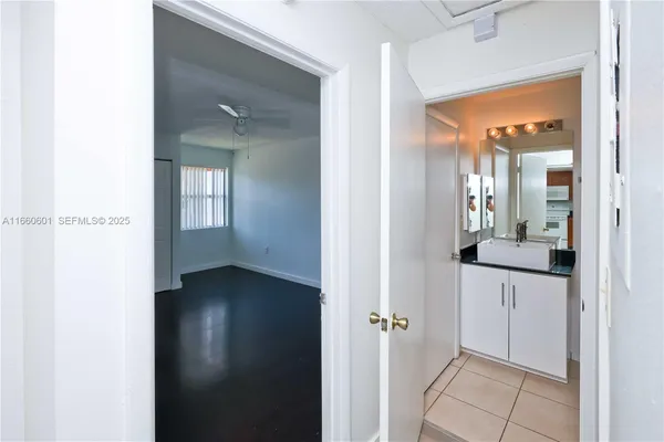 an empty room with a window and a ceiling fan