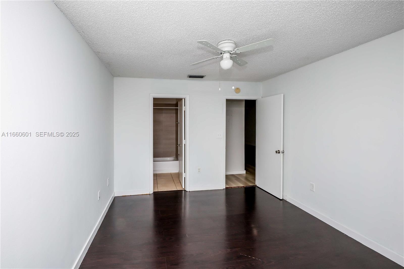 446 Southwest 113th Way, Unit 446 Pembroke Pines, FL 33025 - Photo 20 of 39 a view of an empty room with wooden floor