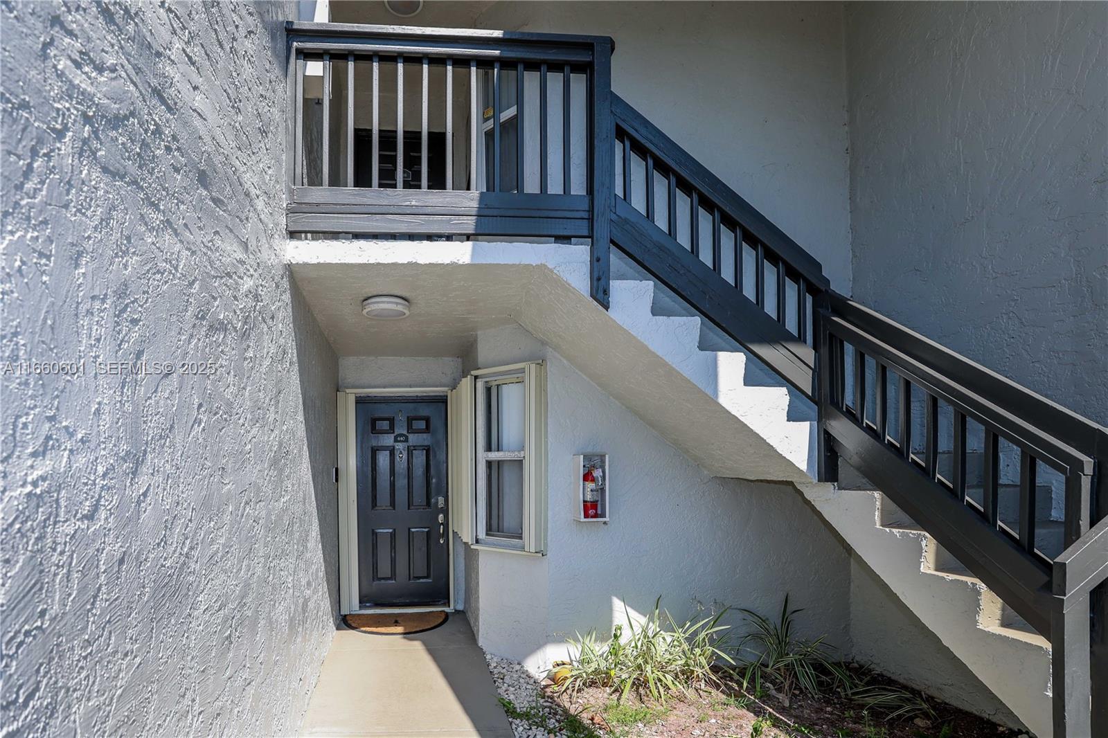 446 Southwest 113th Way, Unit 446 Pembroke Pines, FL 33025 - Photo 37 of 39 a view of entryway with wooden floor and stairs