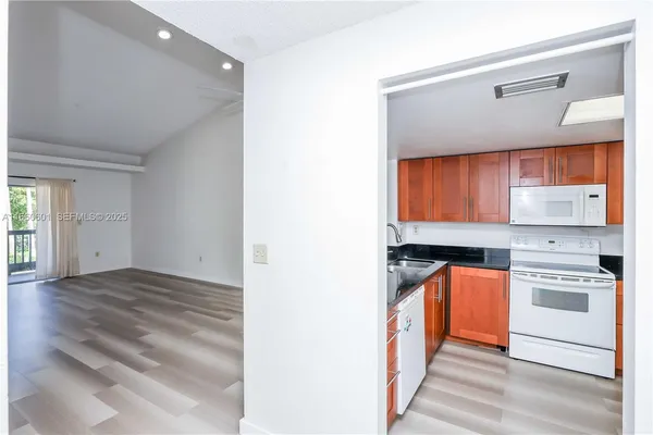 a kitchen with a stove a sink and a refrigerator