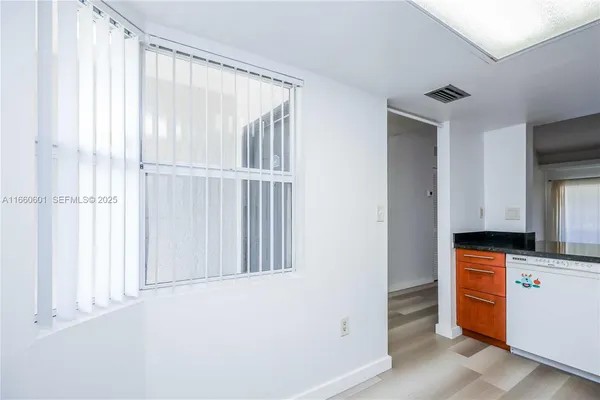 a kitchen with white cabinets and white appliances