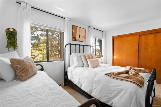 a bedroom with a large bed and a window