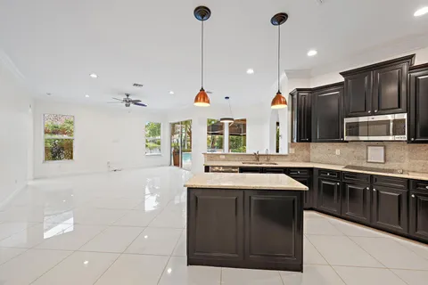 a kitchen with stainless steel appliances granite countertop a sink and a stove