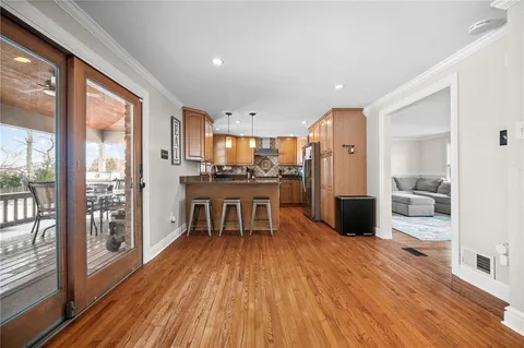 a kitchen with stainless steel appliances granite countertop a refrigerator a stove and a wooden cabinets