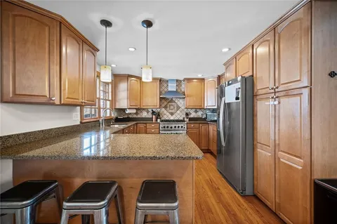 a kitchen with stainless steel appliances granite countertop a stove and a sink