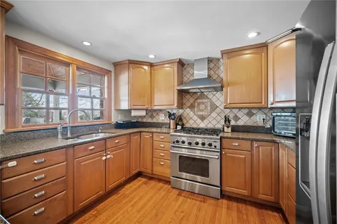 a kitchen with stainless steel appliances granite countertop a stove and a microwave