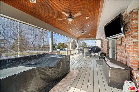 a view of a patio with table and chairs and wooden floor