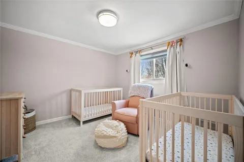 a view of a bedroom with furniture and wooden floor