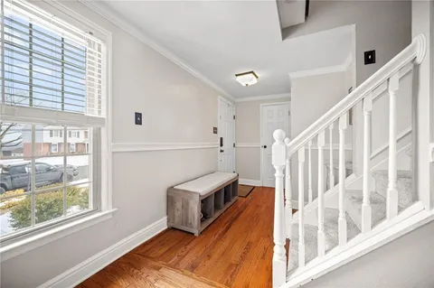 a view of a livingroom with wooden floor and staircase