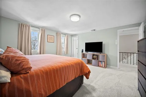 a bathroom with a sink a toilet and shower curtain