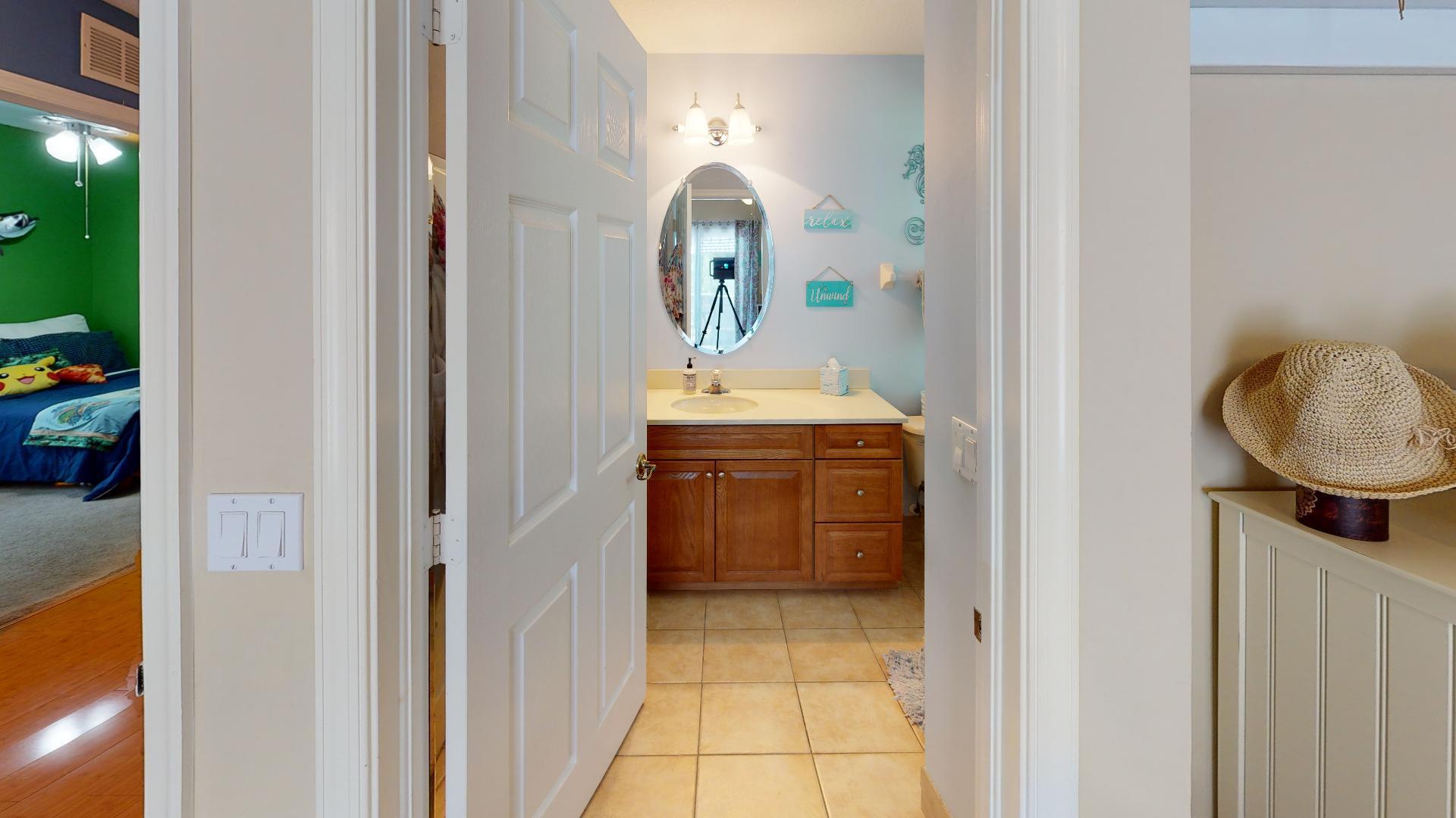150 Sunshine Boulevard Tavernier, FL 33070 - Photo 10 of 26 a en suite bathroom with a sink and a mirror