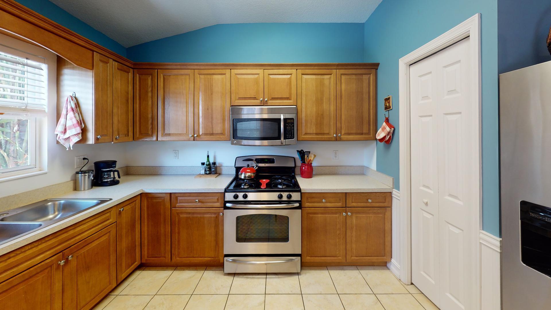 150 Sunshine Boulevard Tavernier, FL 33070 - Photo 5 of 26 a kitchen with a stove a sink and a microwave