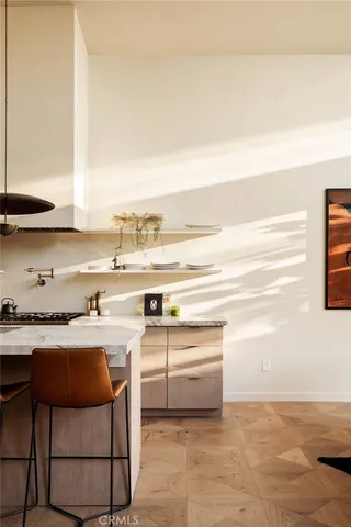 a kitchen with a stove and white cabinets