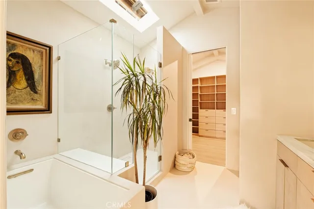 a view of a bathroom with a tub and shower