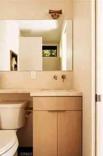 a bathroom with a sink toilet and mirror