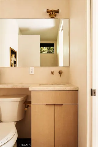a bathroom with a sink toilet and mirror