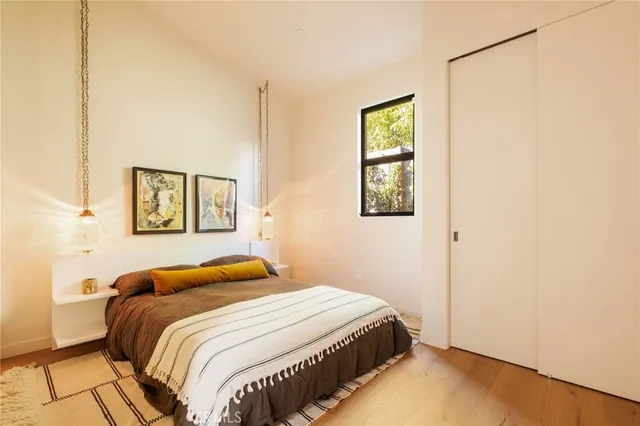 a bedroom with a bed and a window