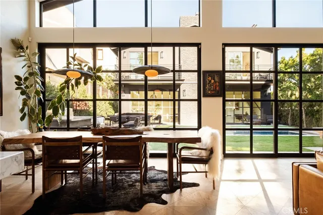 a dining room with furniture a rug and a large window