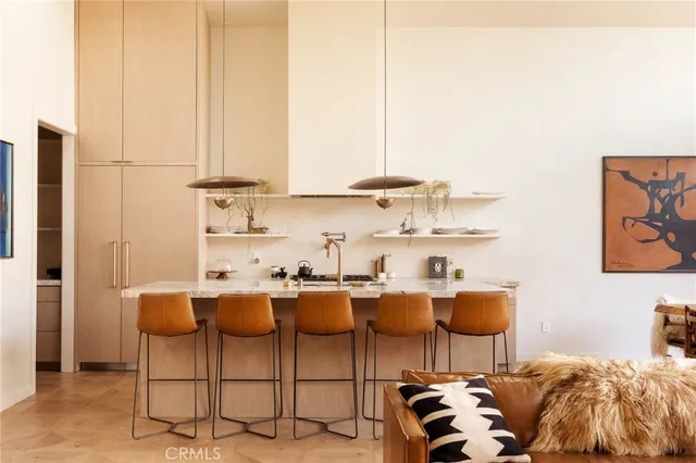 a kitchen with a cabinets and chairs